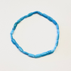 Blue beaded necklace on a light gray background