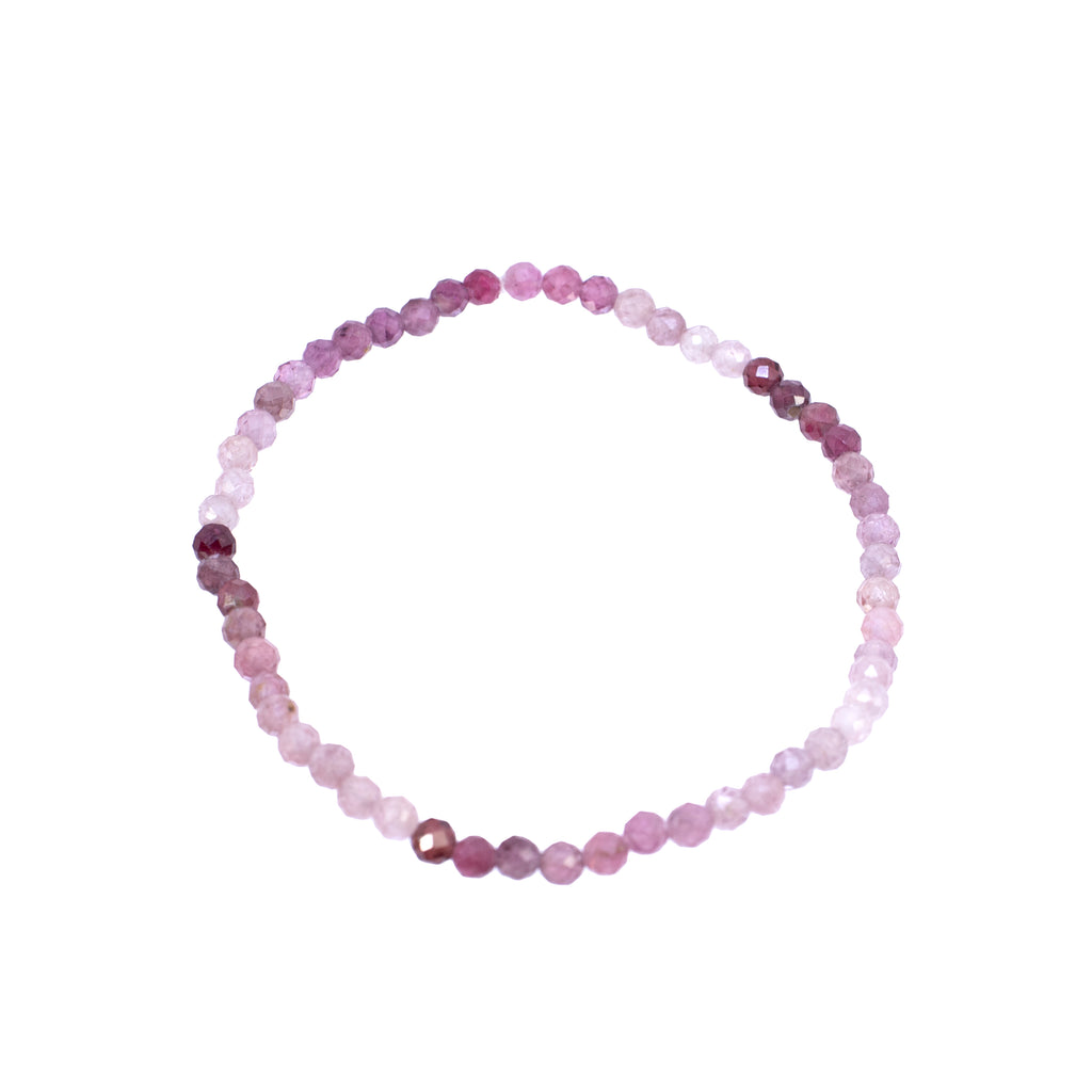 Beaded bracelet with pink and purple stones on a white background