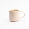speckly off white mug with glossy surface