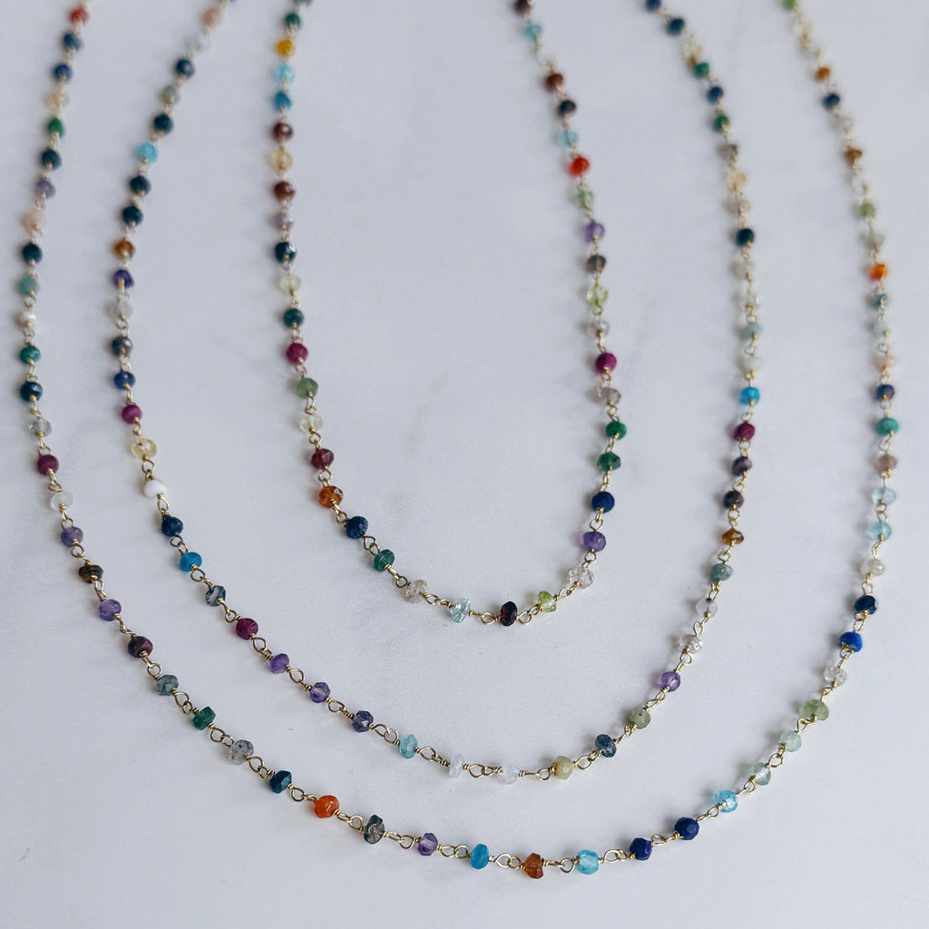 Three multicolored beaded necklaces on a white background