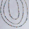 Three multicolored beaded necklaces on a white background