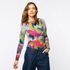 woman wearing long sleeve shirt with a wobbly rainbow design