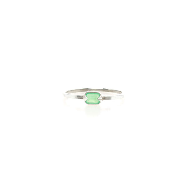 Silver ring with a green gemstone on a white background