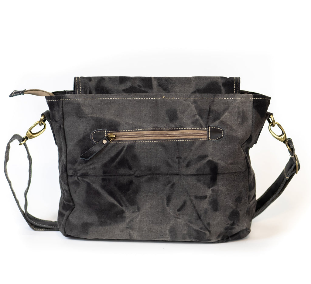 Dark gray handbag with gold accents on a white background