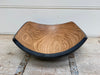 Angled wooden salad bowl with a blackened exterior finish