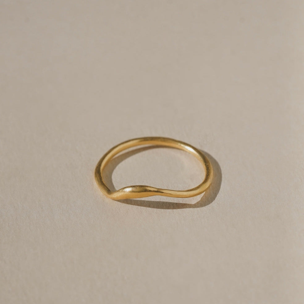Gold ring on a beige background