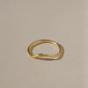Gold ring on a beige background