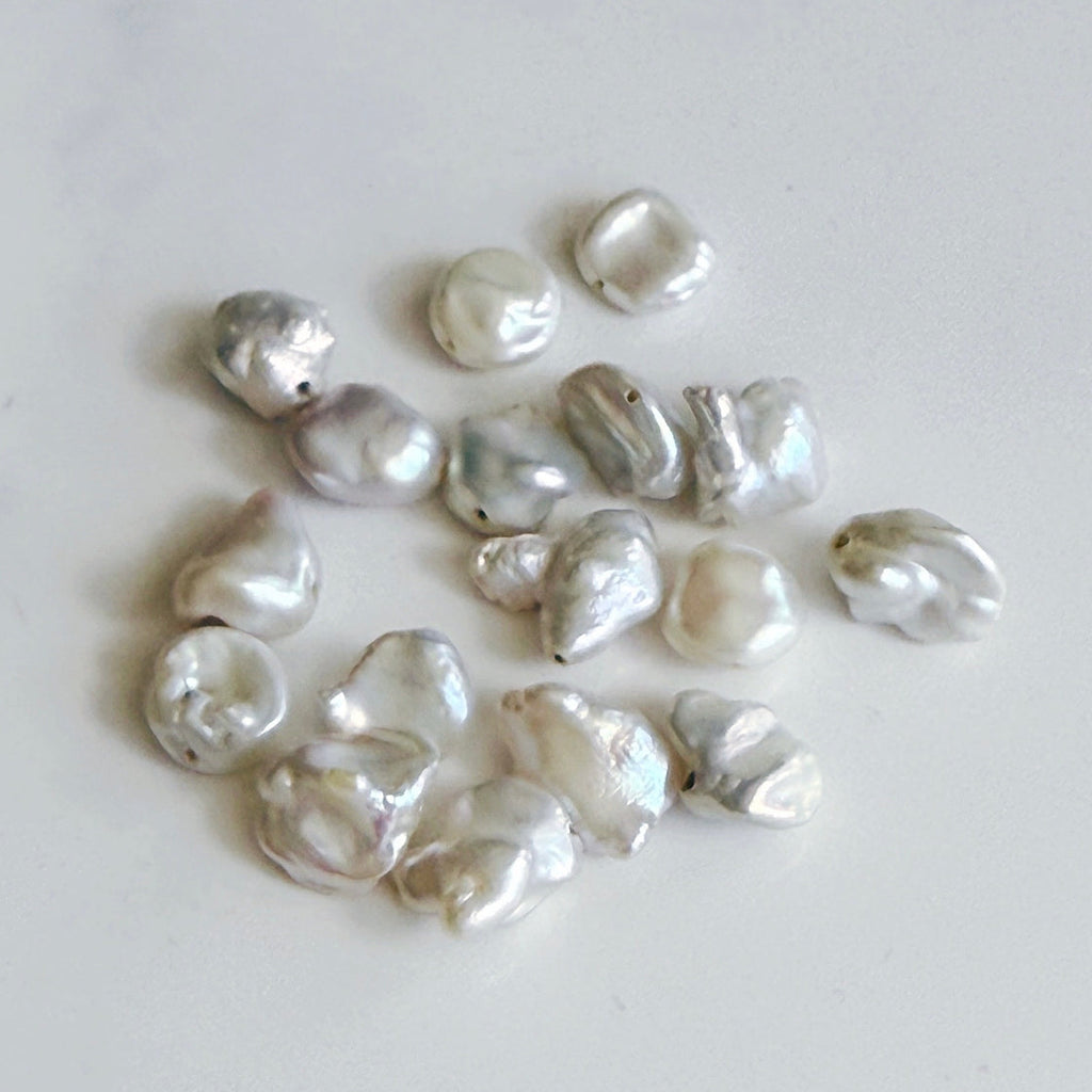 Collection of natural pearls on a light gray background