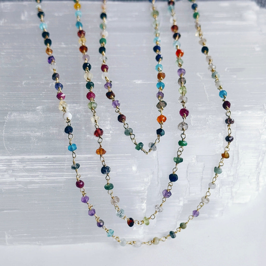 Multicolored beaded necklace on a textured white surface
