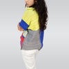 Person wearing a colorful striped sweater and white pants on a plain background