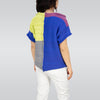 Person wearing a colorful striped sweater and white pants on a plain background
