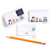Notebook with cat illustrations, pencil, and box on a white background
