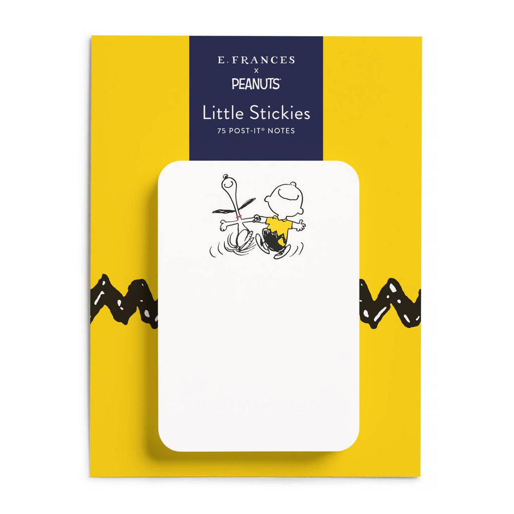 E. Frances Peanuts Little Stickies 75 post-it notes on a yellow backing card with a white sticky note featuring a black-and-white cartoon drawing of Snoopy and a pencil.