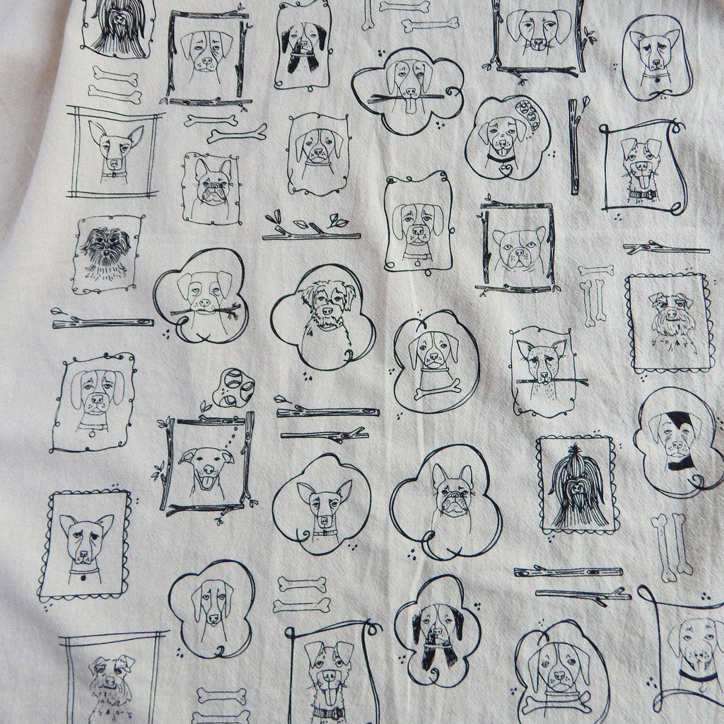 Pattern of black line drawings of dogs and bones on a light background