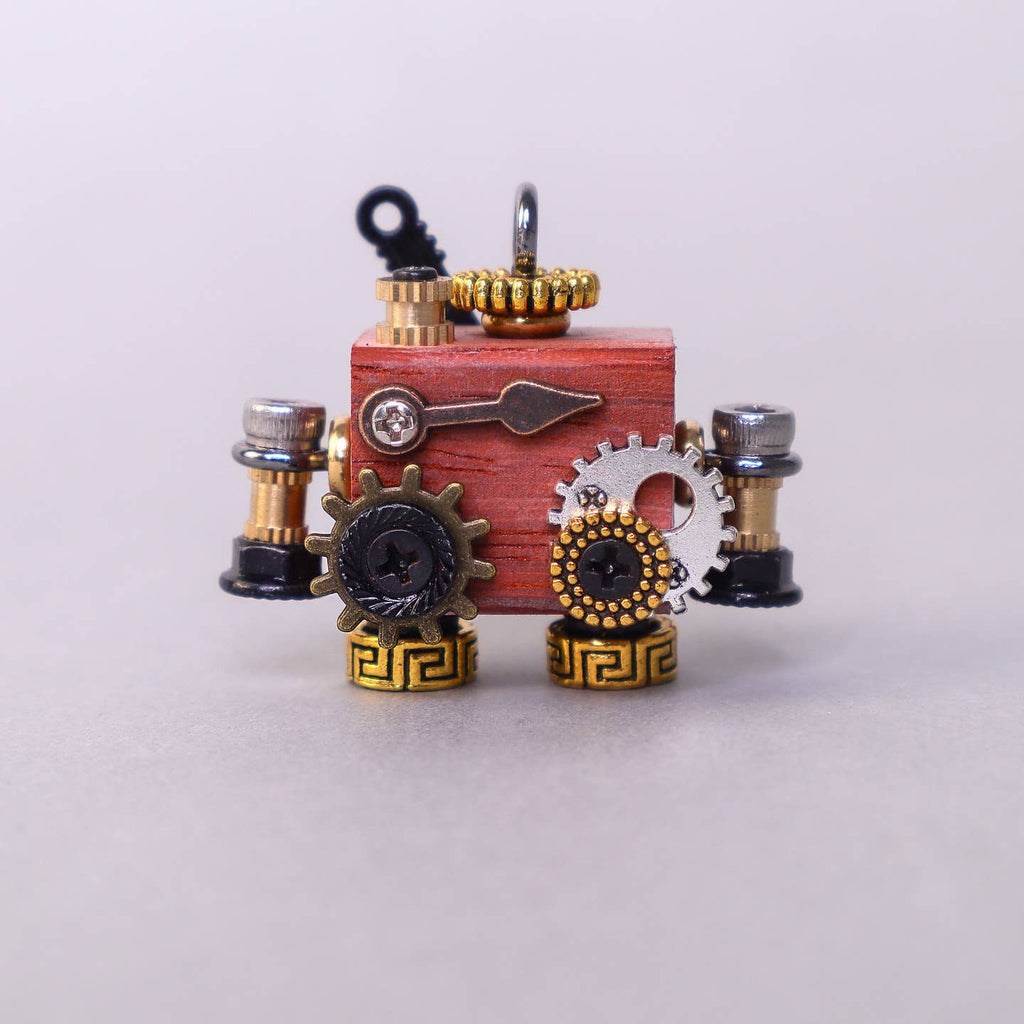 Steampunk-style jewelry set with gears and red box on a light gray background