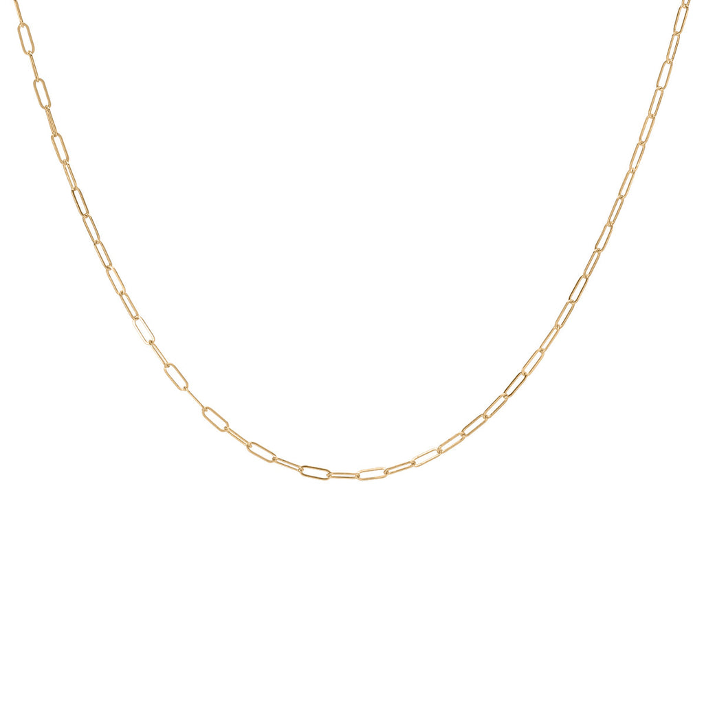 A delicate gold-fill layering necklace chain laid out on a plain background.