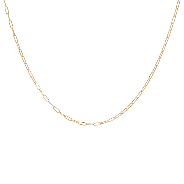 A delicate gold-fill layering necklace chain laid out on a plain background.