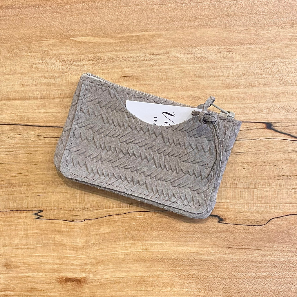Gray textured pouch on a wooden surface