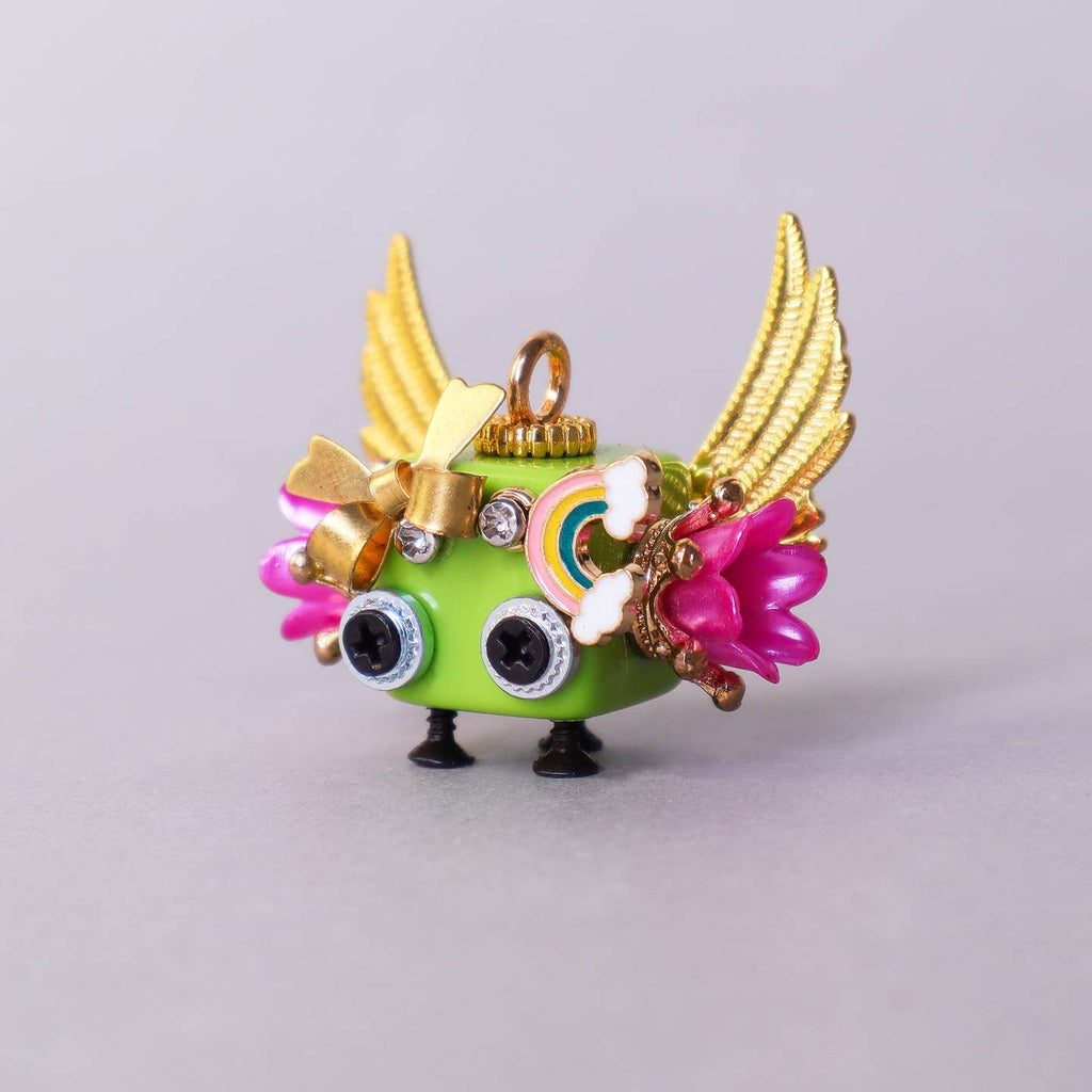 Colorful figurine with gold wings and decorative elements on a light gray background