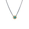 Blue Green round Australian opal with a gold bimetal bezel and textured border. It is attached to an oxidized silver chain.