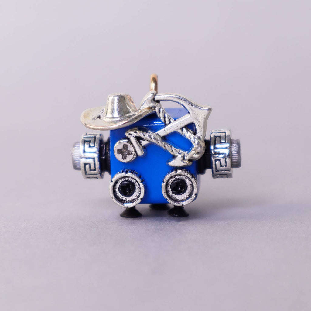 Blue charm with silver accents on a gray background