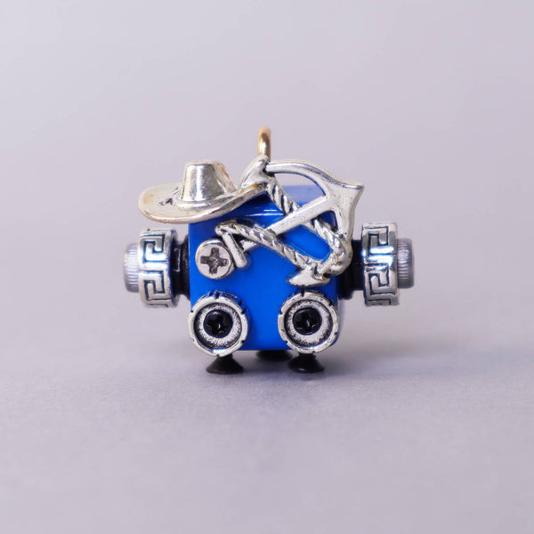 Blue charm with silver accents on a gray background