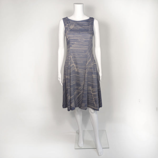 Mannequin wearing cool gray flare spring dress patterned with light yellow lines going horizontal and diagonal. 