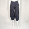 Mannequin wearing navy blue and white striped barrel leg pant. It includes a zipper in the front.