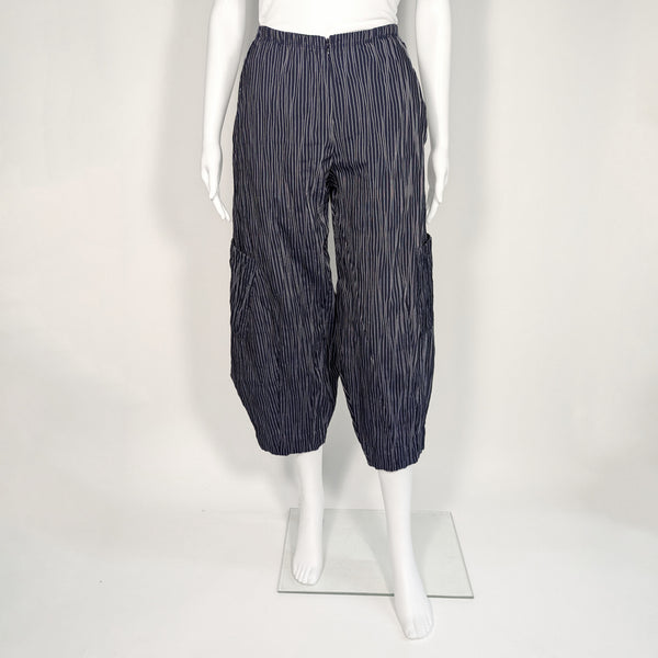 Mannequin wearing navy blue and white striped barrel leg pant. It includes a zipper in the front.