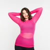 Woman wearing a bright pink long-sleeve top on a white background