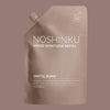 Noshinku Hand Sanitizer Refill pouch in Santal Blanc, featuring a matte taupe pouch with white text and a spout cap, set against a solid taupe background.