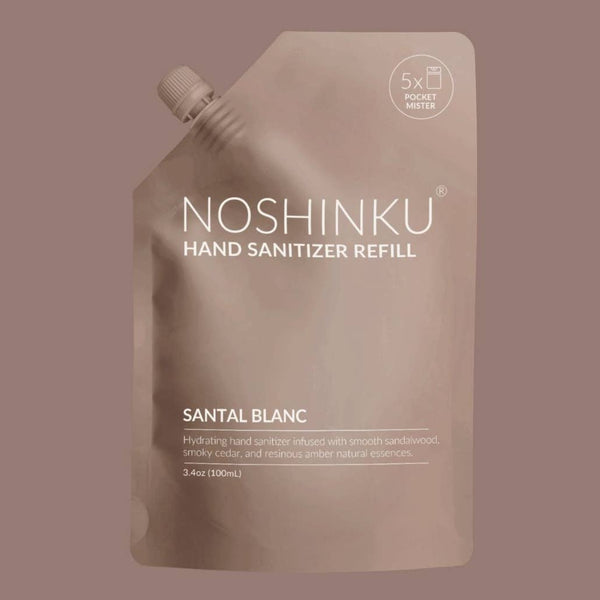 Noshinku Hand Sanitizer Refill pouch in Santal Blanc, featuring a matte taupe pouch with white text and a spout cap, set against a solid taupe background.