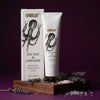 Shea butter hand and body crème with packaging on a wooden block against a purple background