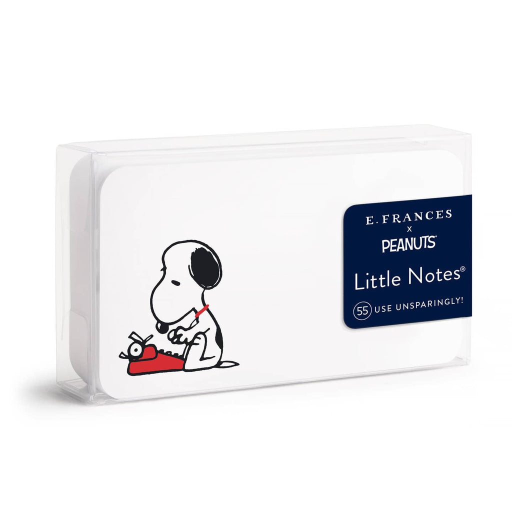 E. Frances x Peanuts Little Notes notebook in a clear plastic case, featuring a black and white cartoon drawing of Snoopy and a red notebook on a white cover, with a navy blue product label on the right.