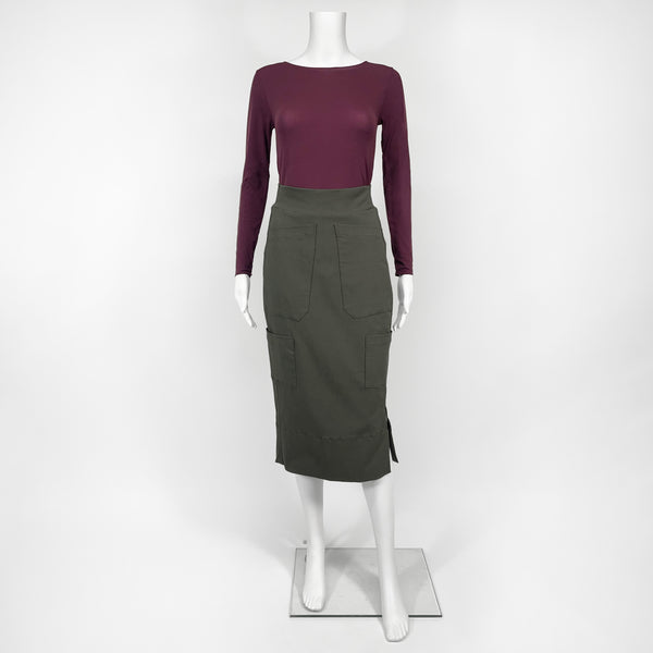 Mannequin wearing a maroon long-sleeve top and green skirt on a white background