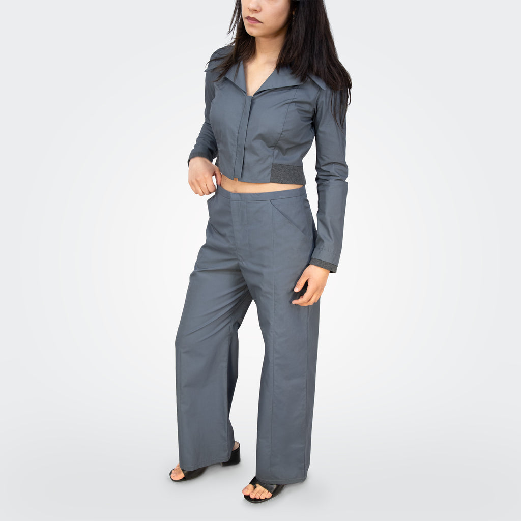 Person wearing a gray outfit on a white background