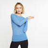 Woman wearing a blue long-sleeve top on a white background