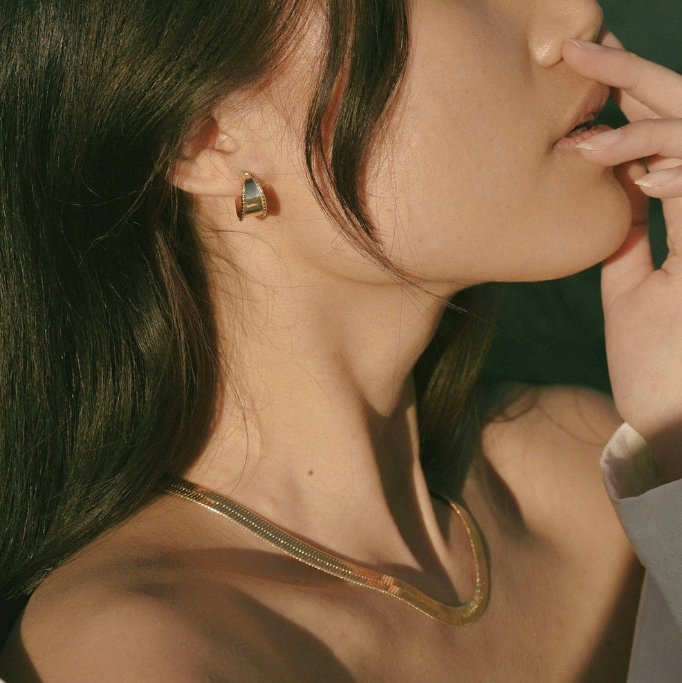 Girl with gold earring and necklace