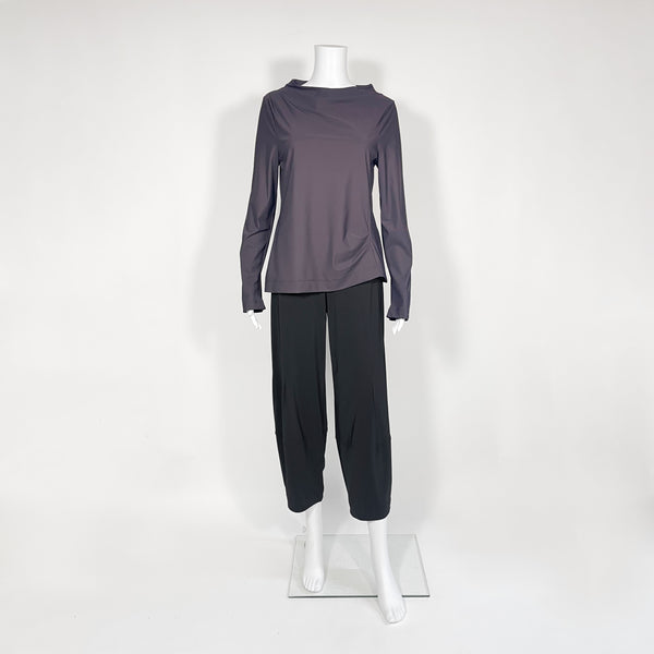 Mannequin wearing a gray long-sleeve top and black pants on a white background