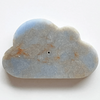 Cloud-shaped stone with a central hole on a white background