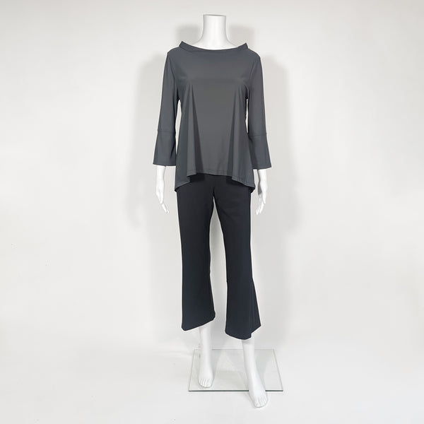 Mannequin wearing a gray top and black pants on a white background