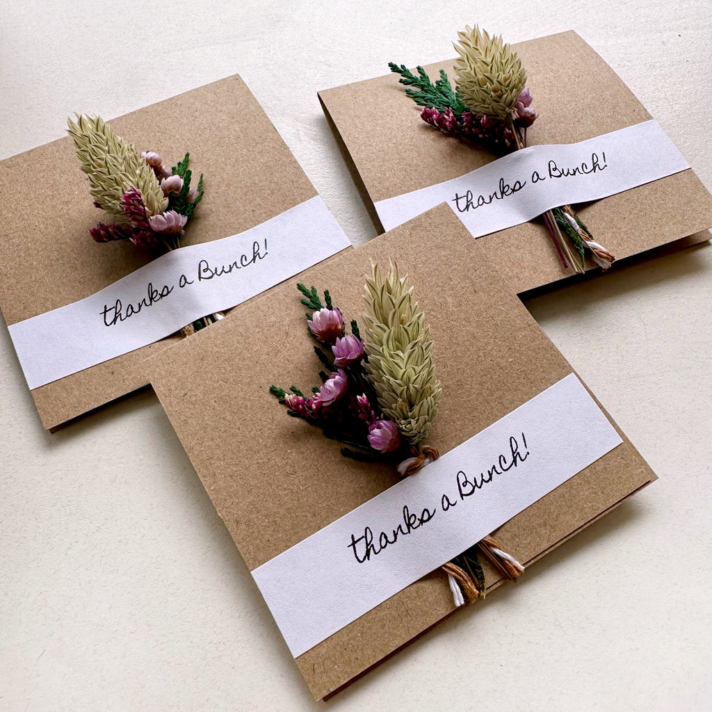 Three brown paper cards with floral decorations and 'thanks a bunch!' text on white background