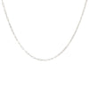 A delicate sterling silver layering necklace chain laid out on a plain background.